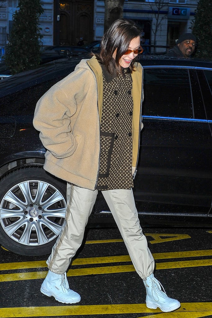 Wearing a Louis Vuitton sweater with camel coat and baby blue combat boots.