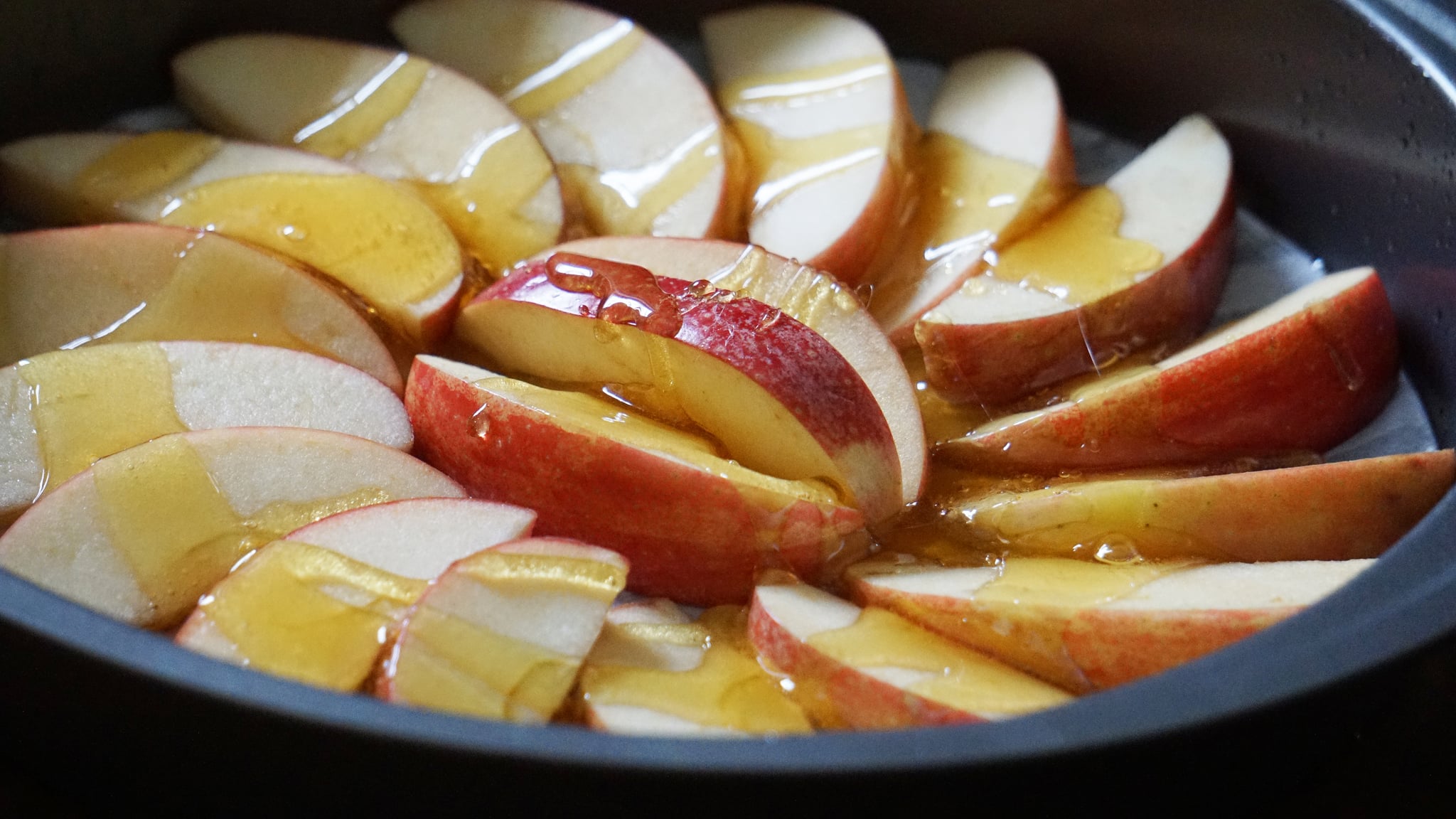 apple honey upside down cake for rosh hashanah dessert: drizzling apples in honey