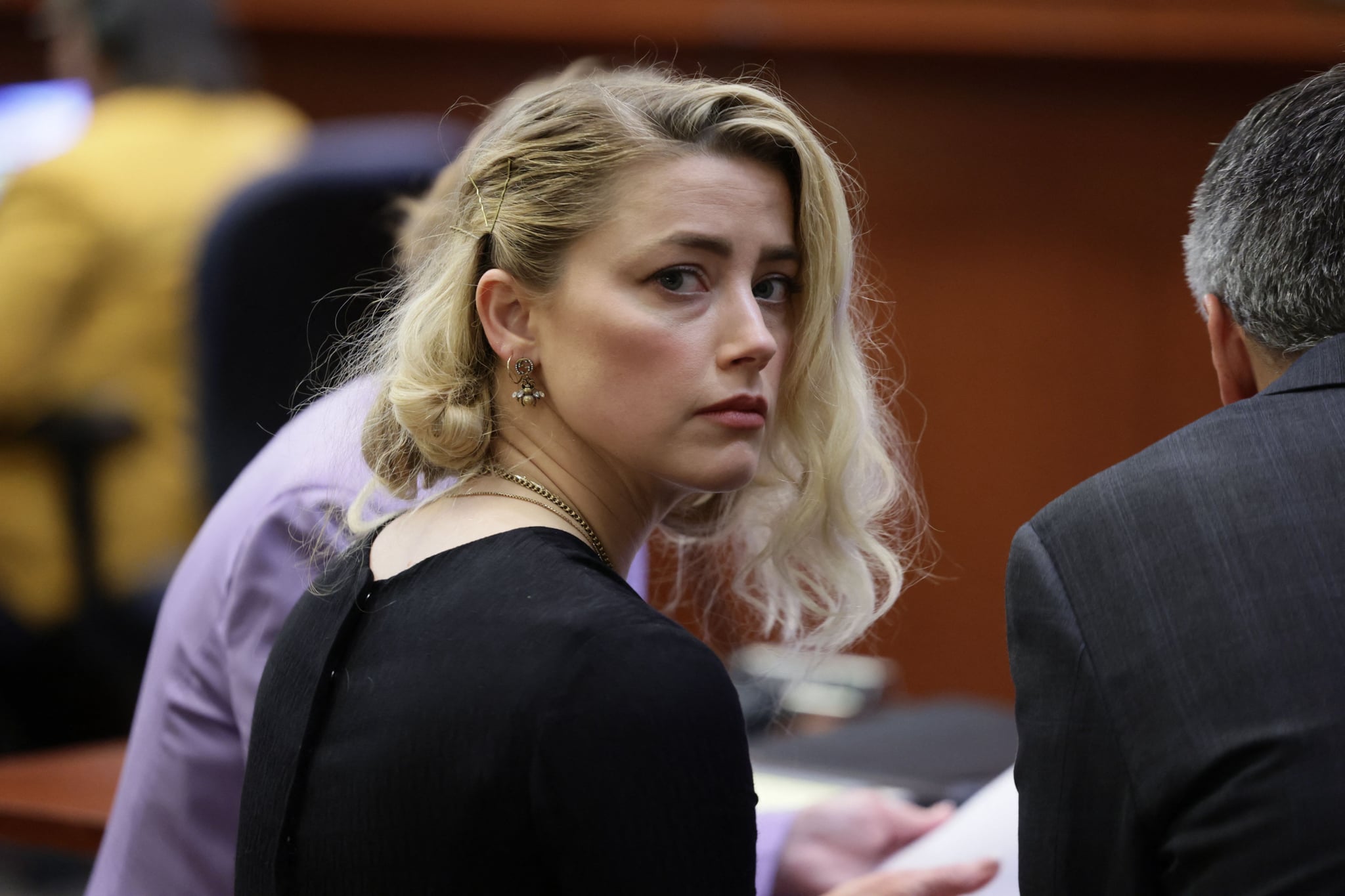 US actress Amber Heard waits before the jury said that they believe she defamed ex-husband Johnny Depp, while announcing split verdicts in favor of both her ex-husband Johnny Depp and Heard on their claim and counter-claim in the Depp v. Heard civil defamation trial at the Fairfax County Circuit Courthouse in Fairfax, Virginia, on June 1, 2022. - A US jury on Wednesday found Johnny Depp and Amber Heard defamed each other, but sided far more strongly with the 