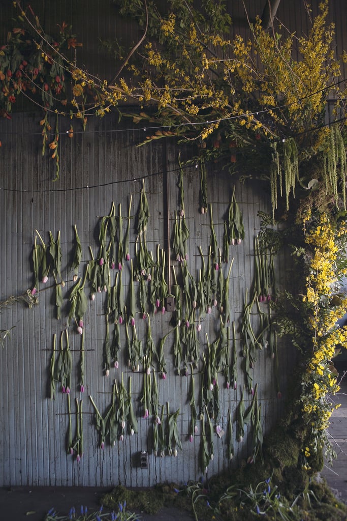 This wall of tulips and floral tree look straight out of a storybook. This wall of tulips and floral tree look straight out of a storybook.