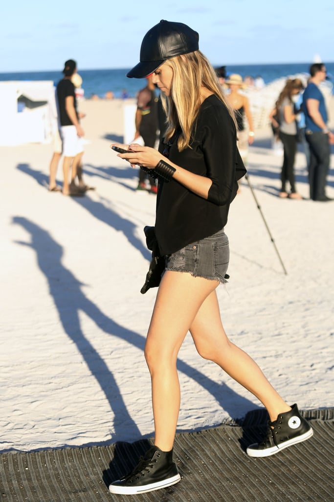 Black isn't basic when it comes with high-top sneakers and a leather baseball cap.