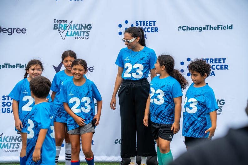 Christen Press with kids during event for Degree campaign Change the Field