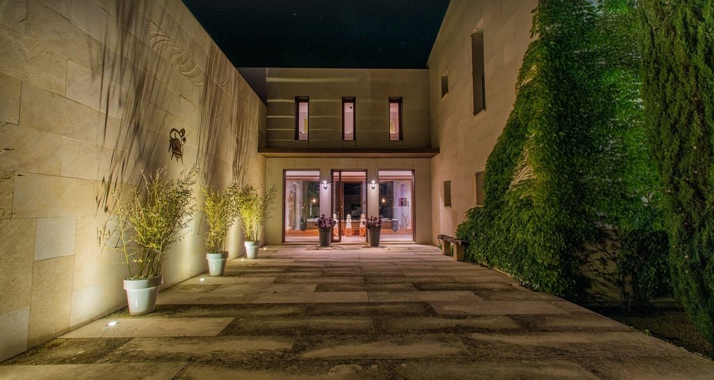 The approach to the villa features a private vine-flanked driveway leading up to the dramatic entrance. Perfect for mastering that "Flack attack" strut!