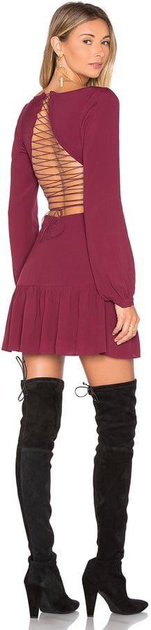 For something you can wear from brunch in the afternoon to drinks at night, wear this maroon For Love & Lemons x Revolve Lace Up Dress ($259).