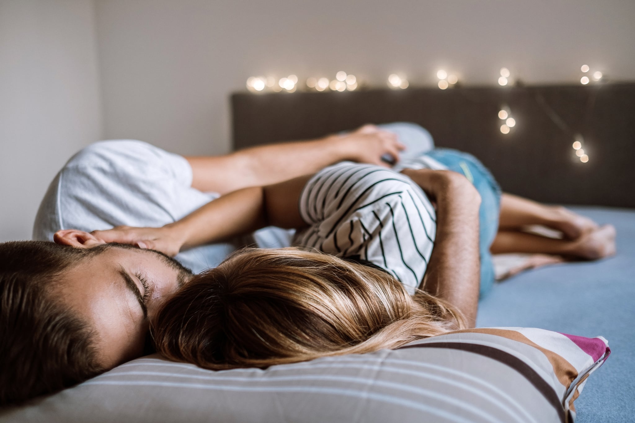 Young sleepy Couple Lying In Bed Together