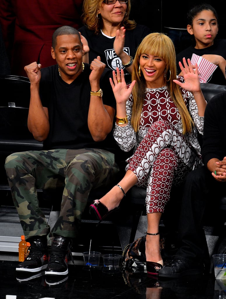 Beyoncé chose a head-to-toe printed Tibi ensemble while JAY-Z styled camouflage pants with a black tee for a courtside appearance in November 2012.