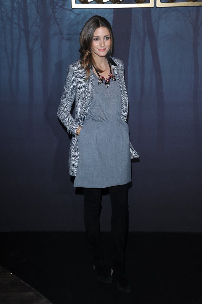 For the latest in a long line of Fashion Week outfits, Olivia put together something fairly simple (save for the necklace). Her basic gray dress was covered with a tailored, long blazer that hit at midthigh for an elongated look.