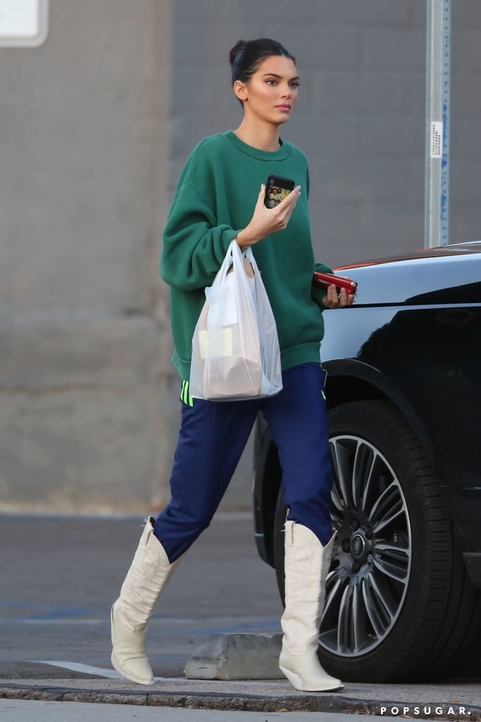 Kendall Jenner White Cowboy Boots and Adidas Track Pants