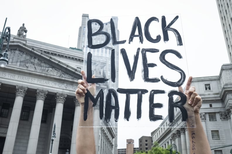 MANHATTAN, NY - JUNE 02: A protester carries a transparent sign above their head against the buildings in  Foley Square that says 