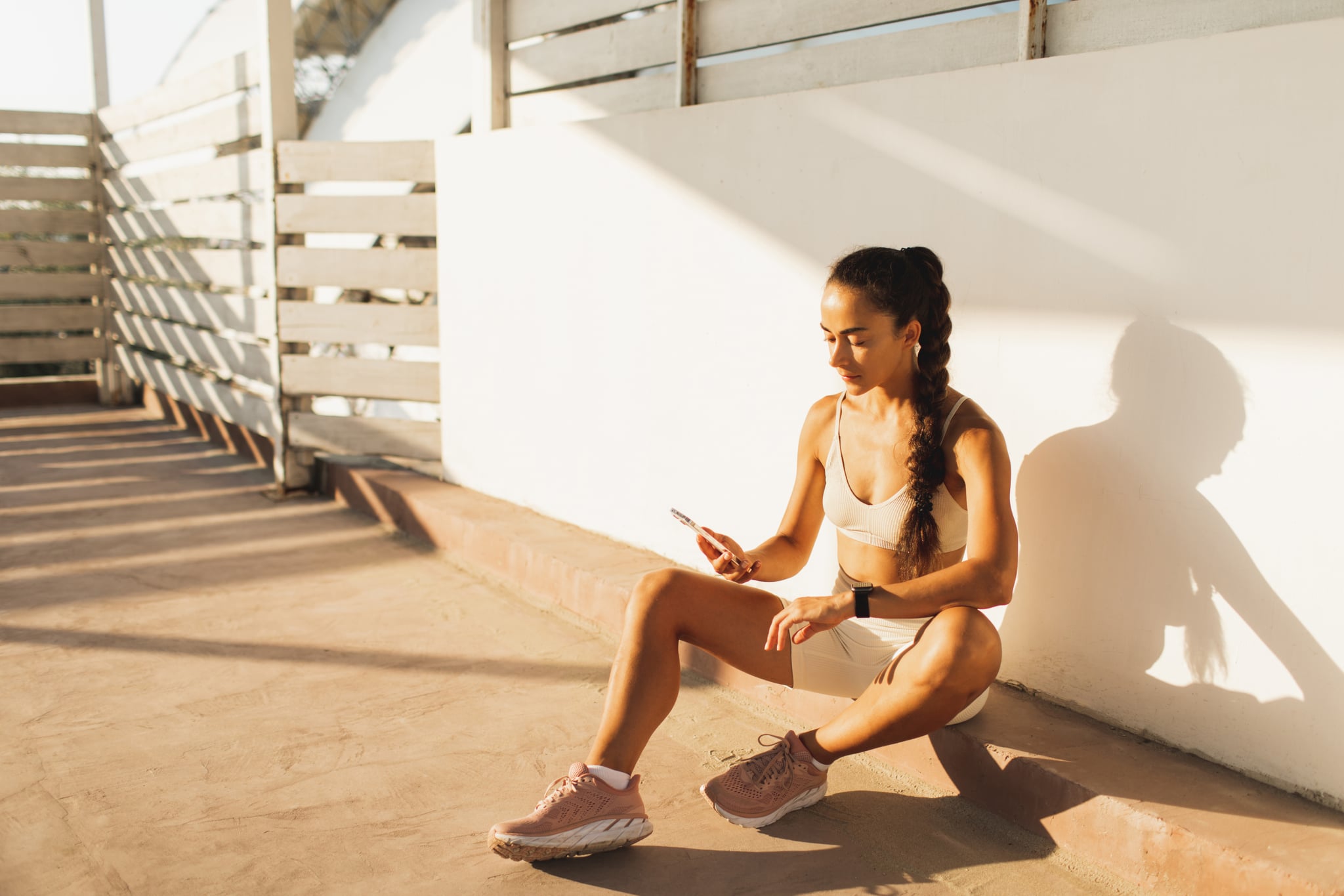 woman getting ready for outdoor workout thinking of a good workout playlist names