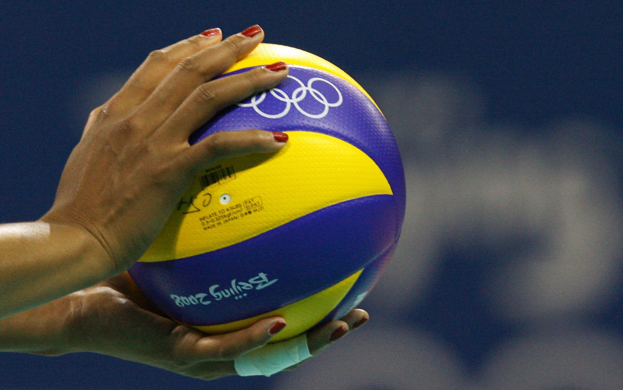 Close-up on the hands of Kimberly Glass of the US holding the ball before serving to members of Cuba's team during their women's preliminary volleyball  Pool B match of the 2008 Beijing Olympic Games at the Capital Gymnasium in Beijing on August 11, 2008. Cuba won the match 3-0.   AFP PHOTO / ALEXANDER JOE (Photo credit should read ALEXANDER JOE/AFP via Getty Images)