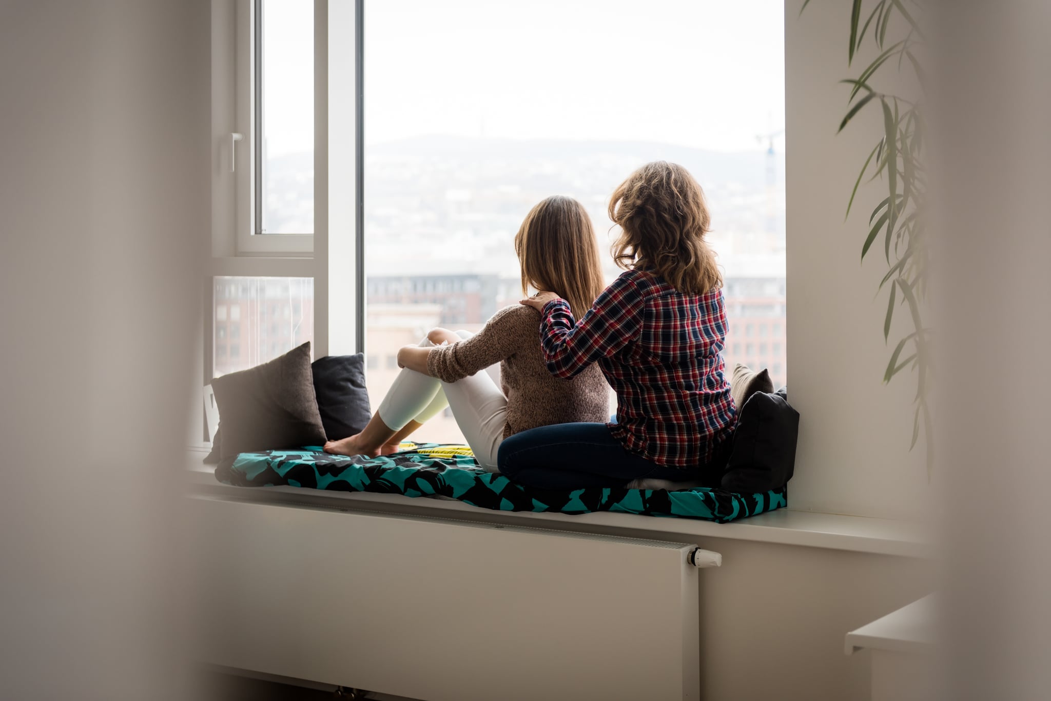 Woman giving massage to her daughter, rear shot.