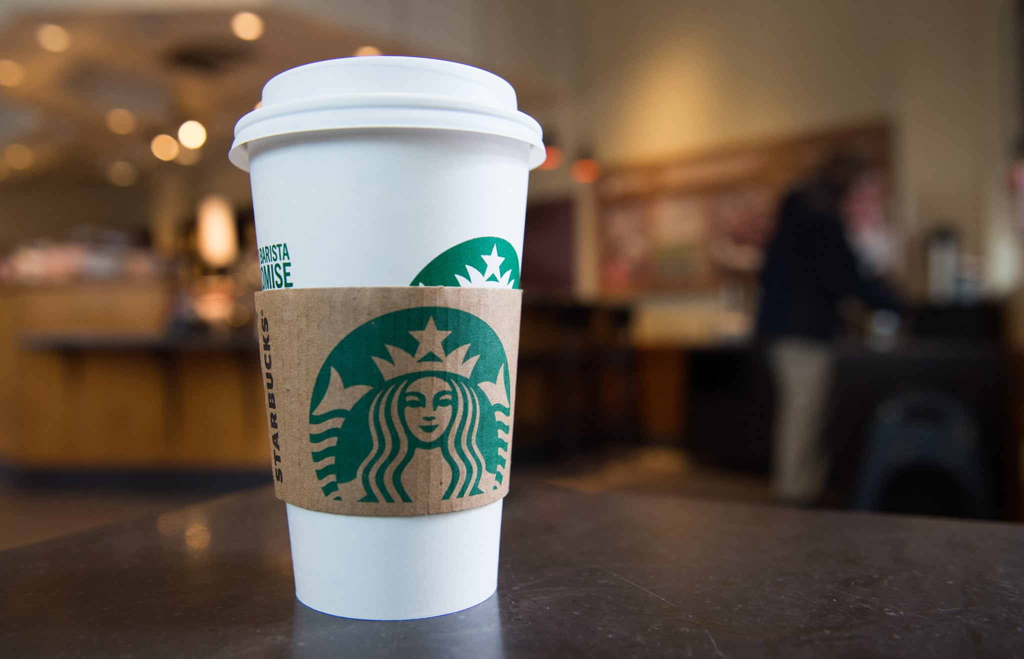 A Starbucks coffee cup is seen inside a Starbucks Coffee shop in Washington, DC, April 17, 2018, following the company's announcement that they will close more than 8,000 US stores on May 29 to conduct