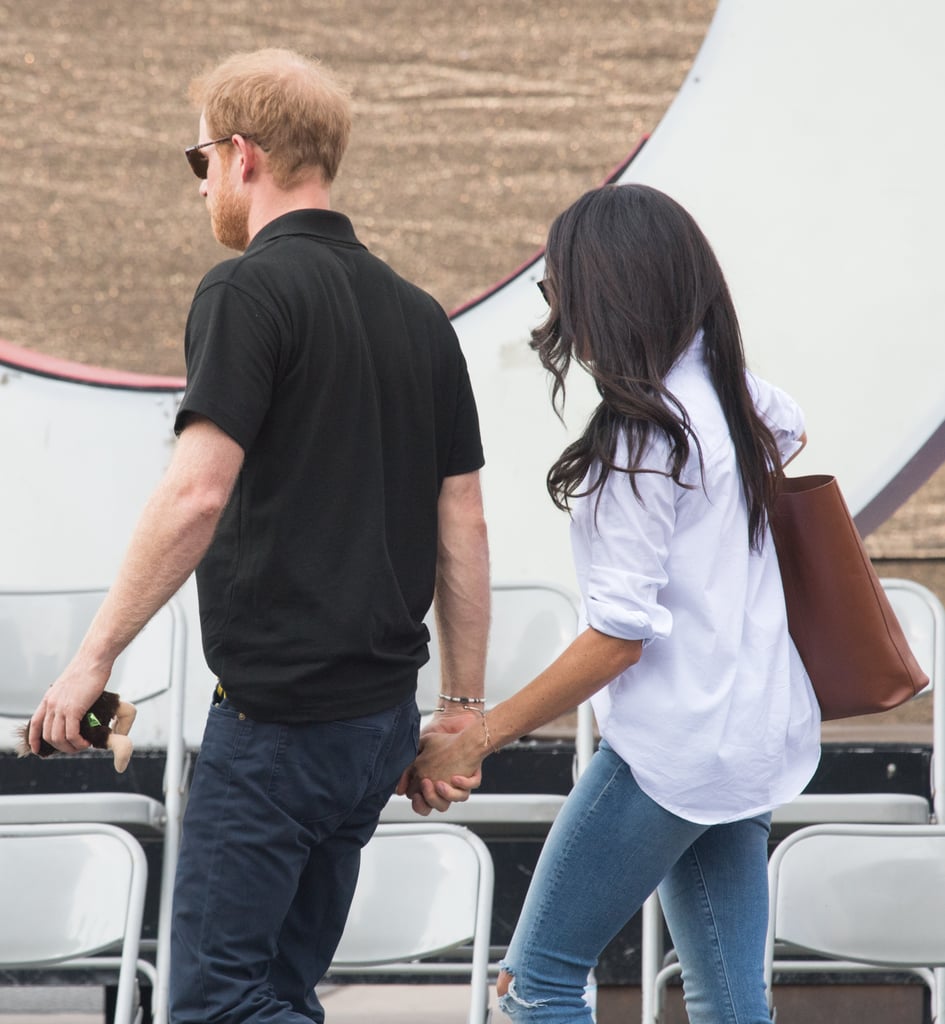 Meghan wore her sleeves rolled up and left the whole shirt untucked.