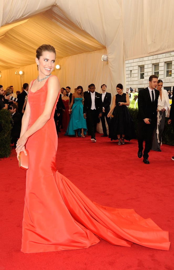 At the 2014 Met Gala, Allison matched her red-orange gown to her clutch perfectly and completed the look with a swept-up hairdo and simple silver jewelry.