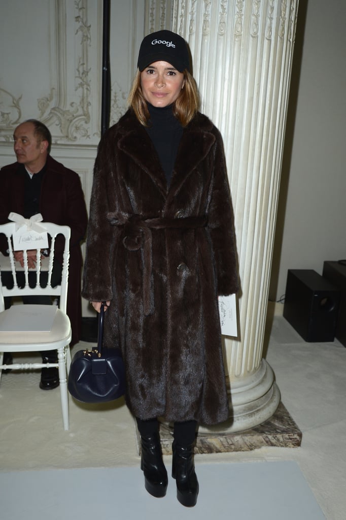 Then, she added a Google cap to her luxe coat at the Giambattista Valli show.