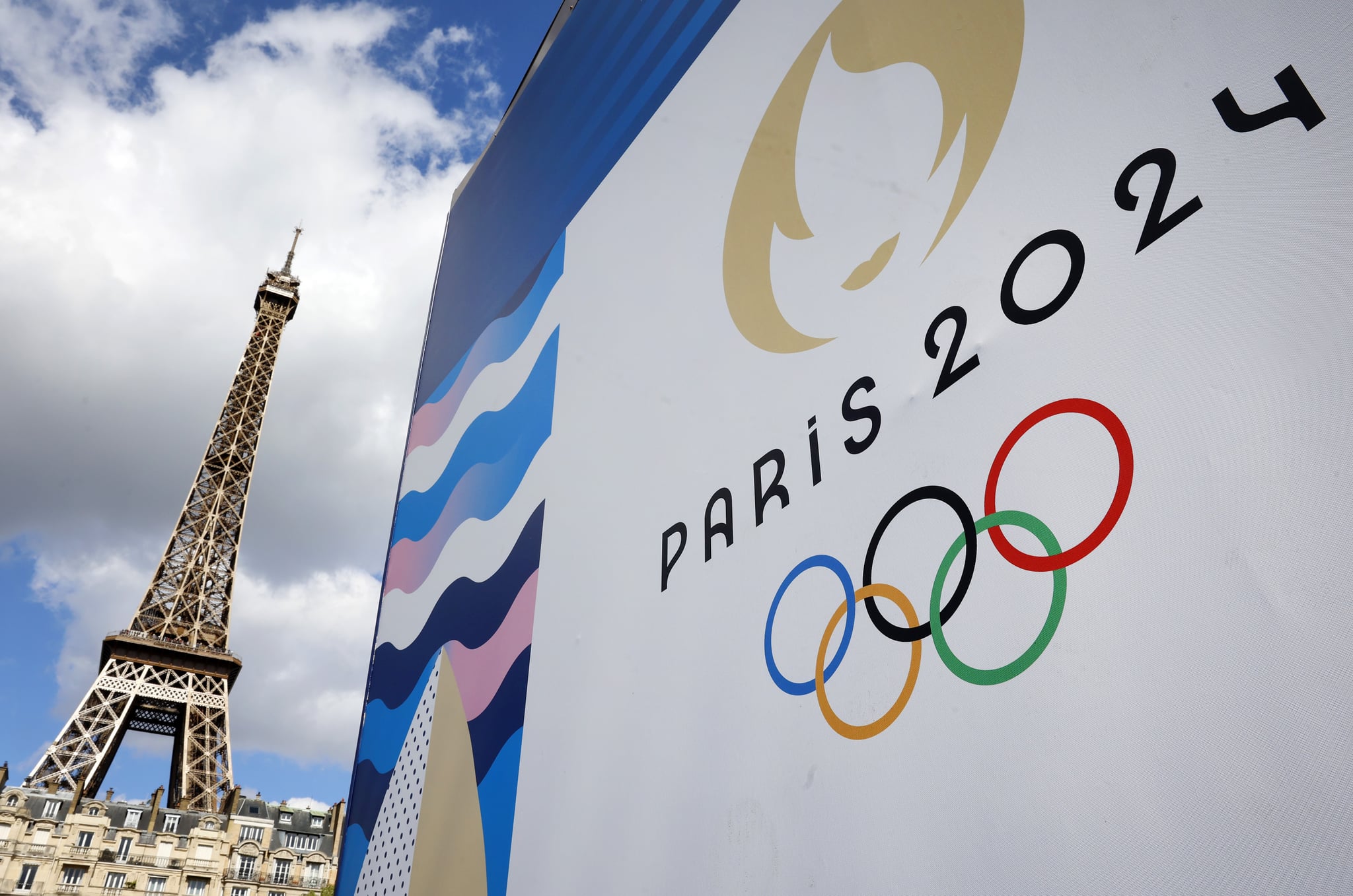 PARIS, FRANCE - APRIL 21: The Paris 2024 logo, representing the Olympic Games is displayed near the Eiffel Tower three  months prior to the start of the Paris 2024 Olympic and Paralympic games on April 21, 2024 in Paris, France. The city is gearing up to host the XXXIII Olympic Summer Games, from 26 July to 11 August. (Photo by Chesnot/Getty Images)