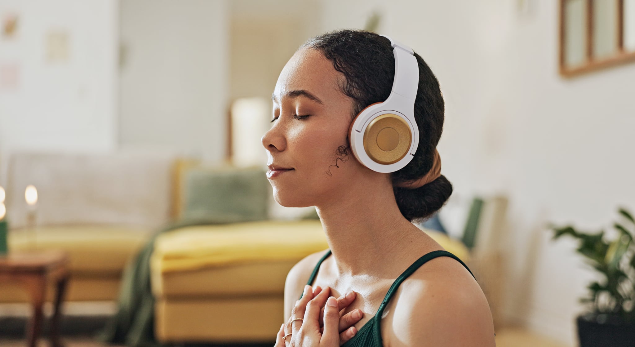 Woman, meditation and yoga in headphones listening to calm music, holistic exercise and peace in living room. Young person with audio podcast, dream of health and relax in spiritual wellness at home