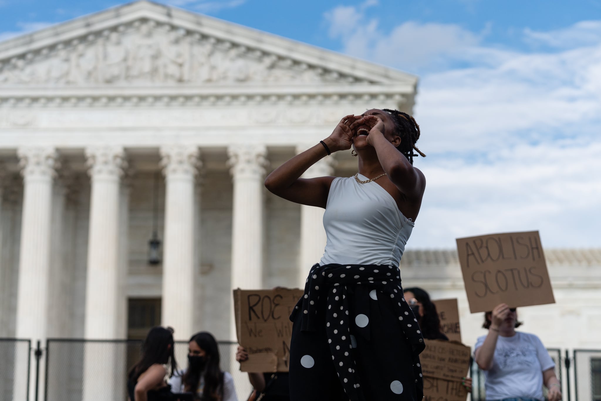 An abortion rights demonstrator leads a chant outside the US Supreme Court in Washington, D.C., US, on Monday, June 27, 2022. A CBS News poll suggested that a majority of Americans disapprove of the Supreme Court's decision overturning the constitutional right to an abortion, which is inflaming a partisan divide on display in comments by senior lawmakers. Photographer: Eric Lee/Bloomberg via Getty Images
