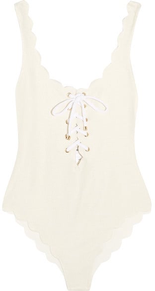 "The silhouette's a classic, but we love the subtle scalloping, lace-up detailing, and the perfect shade of white on this  Marysia Swim Palm Springs Swimsuit ($350) — the kind that was made for showing off your tan." — HWM