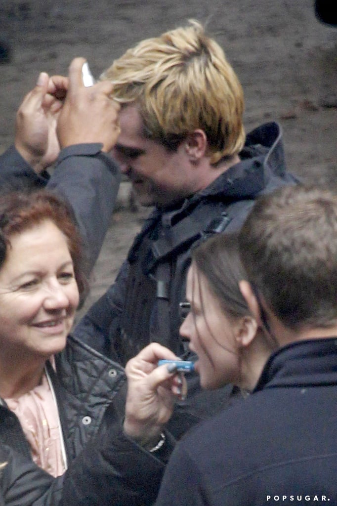 A stylist adjusted Hutcherson's hair during a break.