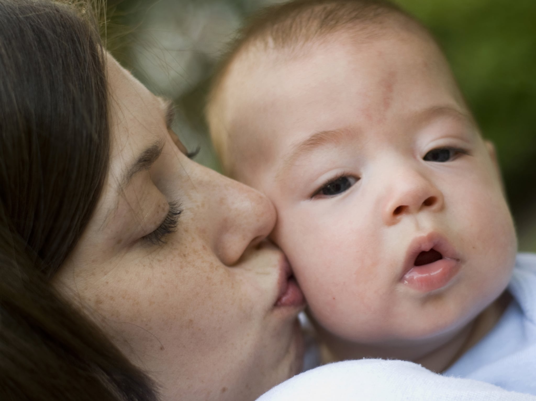 Mother kissing her four month old baby boy