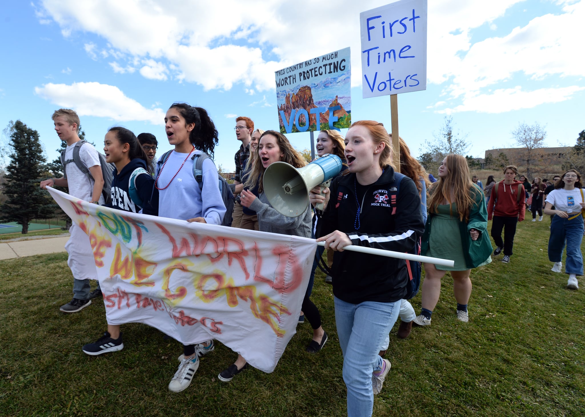 BOULDER, CO - October 25, 2018:  Owen Hushka, left, and Vanessa Haggans, hold a banner while marching, with other students and staff of Fairview High School, to the South Boulder Recreation Centre to vote and turn in election ballots in early voting in Boulder, Colourado on Thursday October 25, 2018. 
