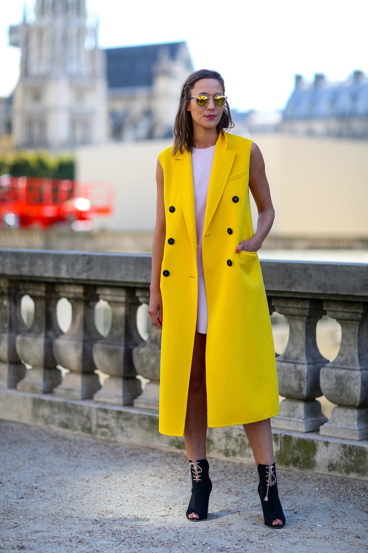 How cool is this bright yellow, sleeveless Dior coat? Best Street