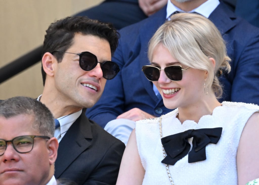 Lucy Boynton and Rami Malek's romance dates back to 2018. After much speculation, Malek confirmed their relationship at the Palm Springs International Film Festival on Jan. 3, 2019. While accepting the award for breakthrough artist, he thanked Boynton for her support, adding, "You have been my ally, my confidant, my love." 
Then, at the Golden Globes a few days later, the couple continued to be award season's sweetest duo, and as Malek celebrated more wins at the SAG Awards and BAFTA Awards, he snuck a kiss from Boynton before heading to the stage. Most recently, the pair made a rare appearance together at Wimbledon, where they were spotted sharing a few laughs in the stands.
Since finding out that Malek and Boynton are dating, we have a whole new appreciation for their on-camera moments in the Freddie Mercury biopic, "Bohemian Rhapsody." In the film, Malek takes on the role of Mercury while Boynton plays his lesser-known muse and former partner, Mary Austin. Mercury was known to write a string of songs for Austin, including "Love of My Life" from Queen's 1975 album "A Night at the Opera."
Malek and Boynton's public embraces are even sweeter off screen, so read on for a look at the duo's real-life romance.