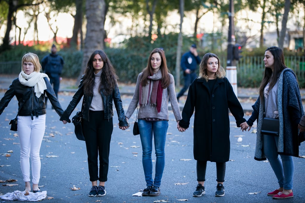 Friends held hands to pay tribute to victims in Paris.