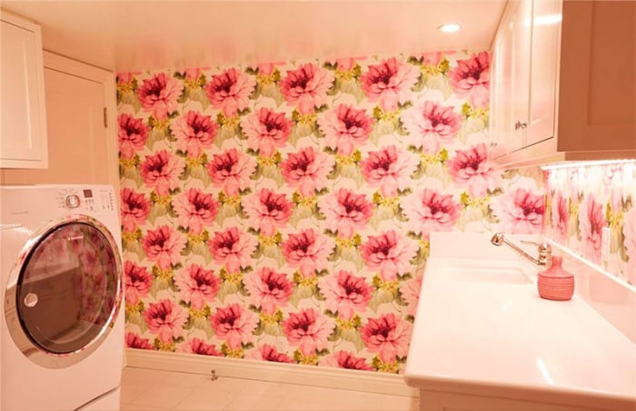 Even the laundry room is full of Lauren's signature touches, like the girlie statement wallpaper.