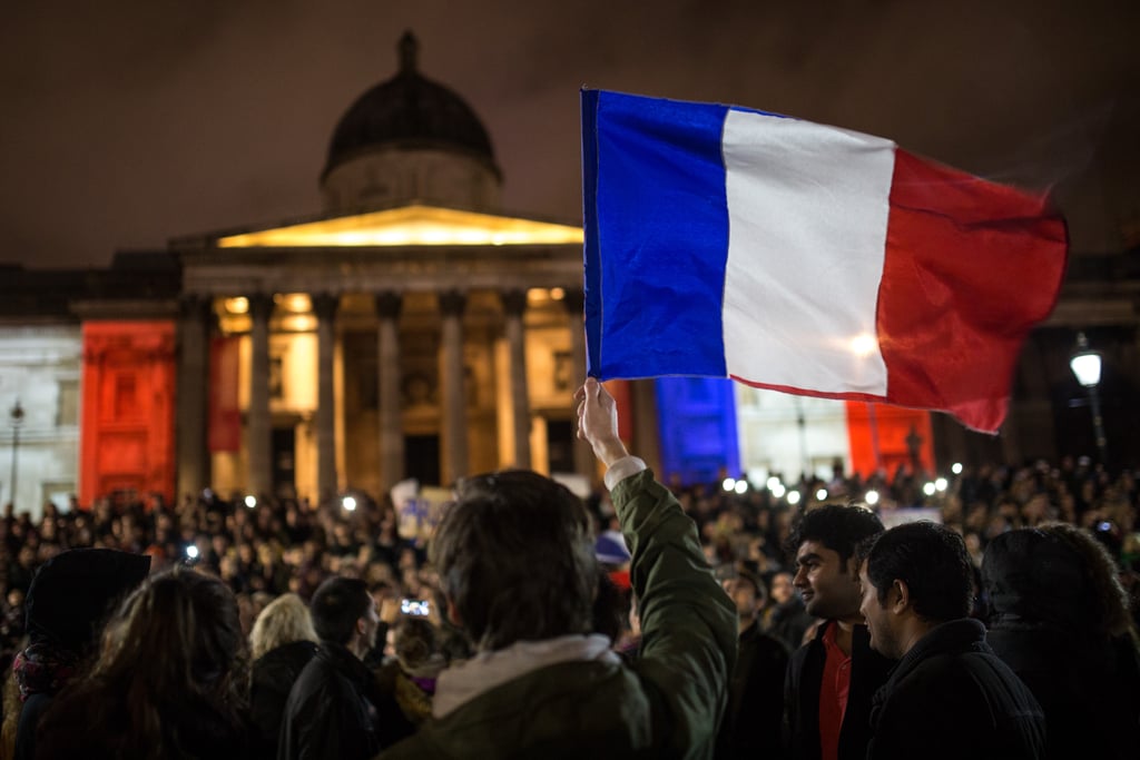 Crowds waved the French flag while paying respects in London's Trafalgar Square.