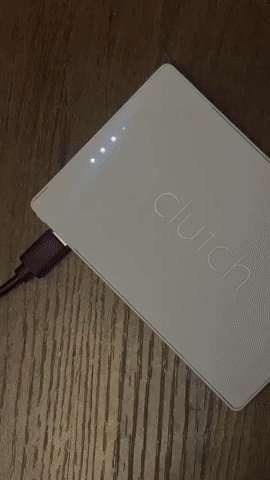 process of charging the Clutch Pro Lightning Portable Charger and then plugging it into an iPhone device