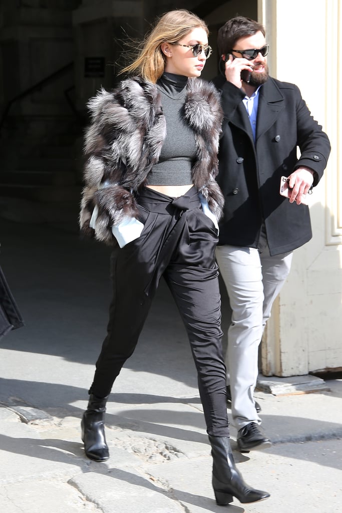 Gigi met her satin trousers with a cropped turtleneck top, finishing off her postrunway outfit with a Waldrip furry coat, Sandro boots, and Krewe du Optic lenses.