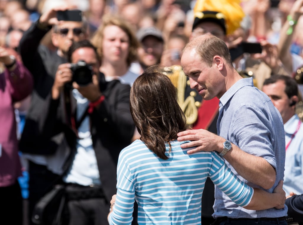 Will and Kate kept their hands around each other while posing for photos during a tour of Germany in July 2017.