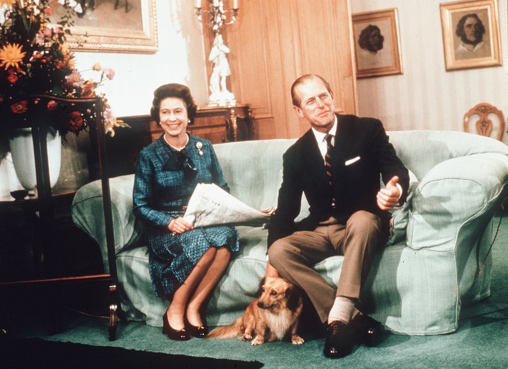 The royal pair sat with their pup at Scotland's Balmoral Castle in 1974.