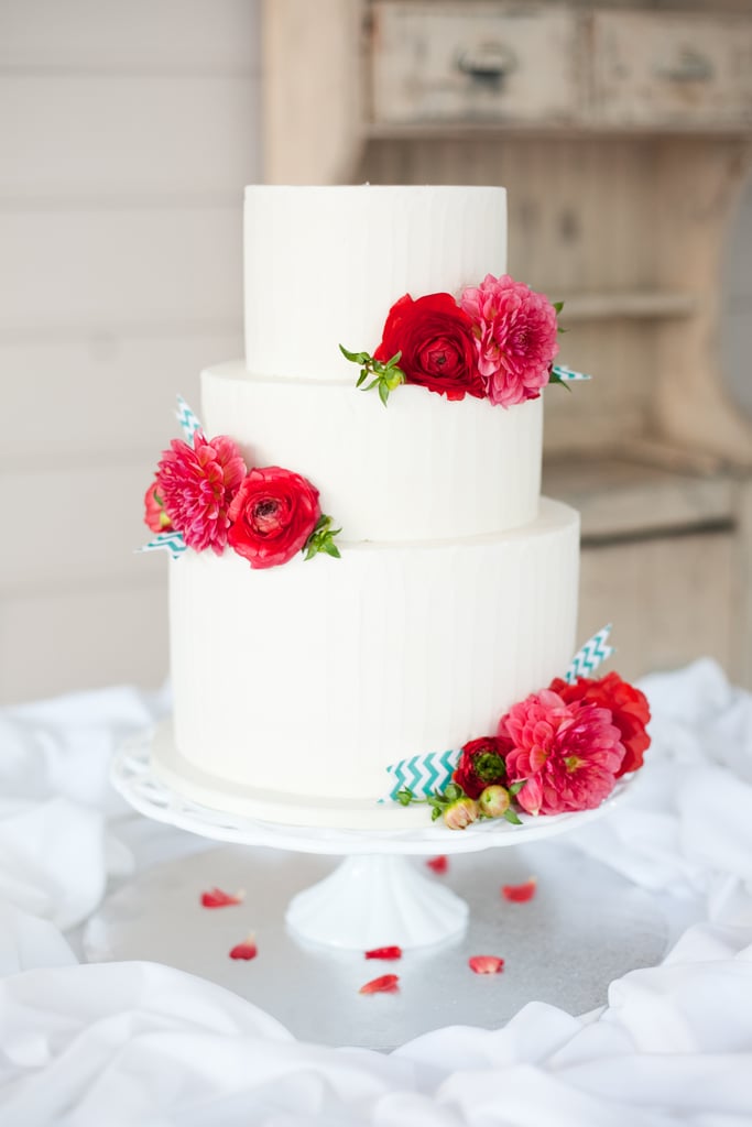 Breathe life into an uncomplicated white cake with bursts of color via bright flowers. It's an easy but oh-so-stylish way to upgrade your celebration.