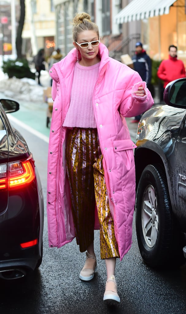 Gigi looked like a badass Barbie in a Christina Ledang puffer with pair of pleated printed pants from Christopher Bu. Gigi styled her sparkly pants with a pair of Filling Pieces biege kicks and mini Ilesteva sunglasses.