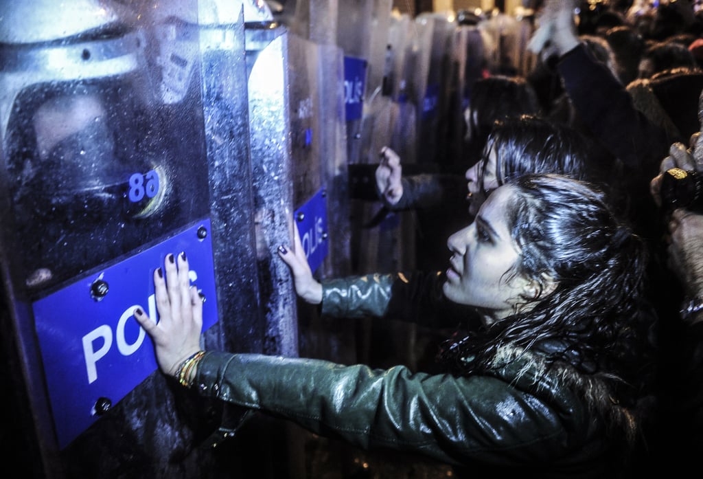 Turkish women went face to face with police officers while marching toward Taksim Square in Istanbul.