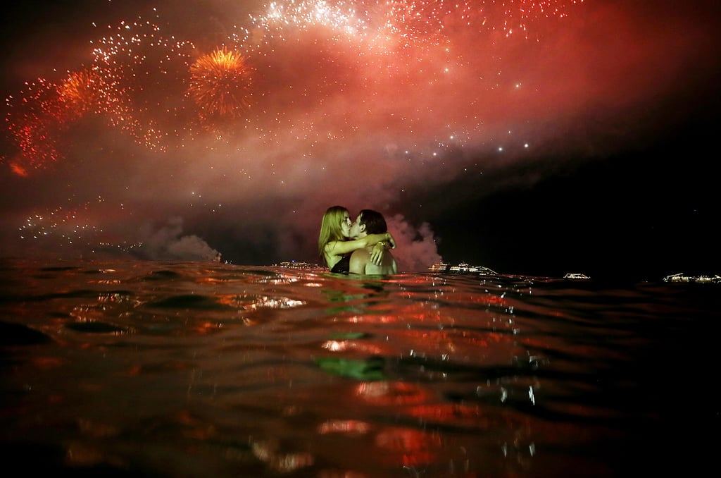 A makeout session took place under the fireworks and in the water in Rio de Janeiro, Brazil.