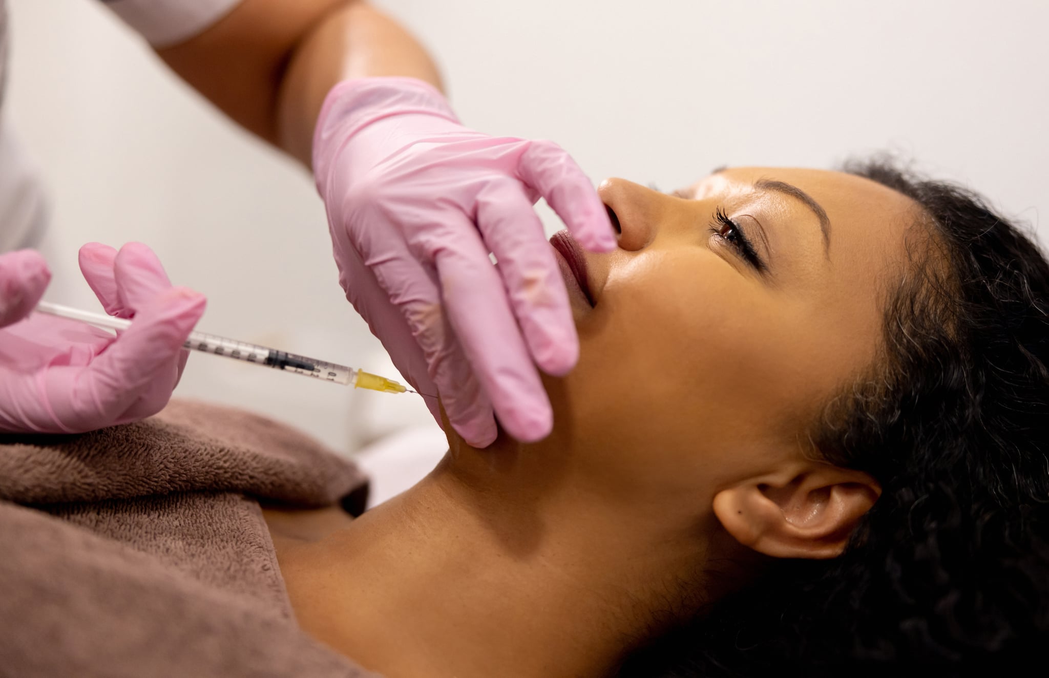 Woman getting chin filler.