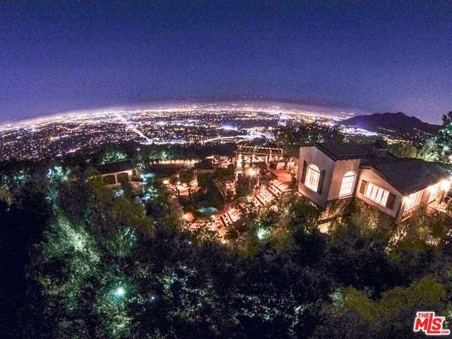 The ultraprivate 2.5-acre Hollywood Hills property affords sweeping city, canyon, and mountain views.