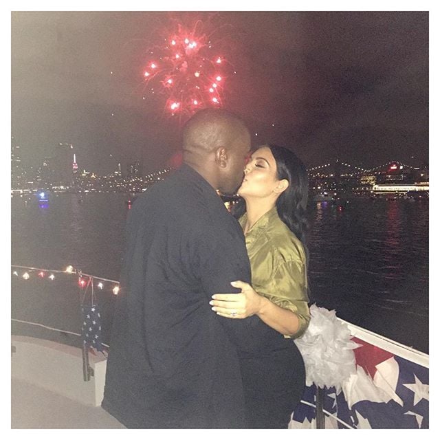 Kim Kardashian and Kanye West shared a sweet kiss as fireworks went off in the distance behind them.