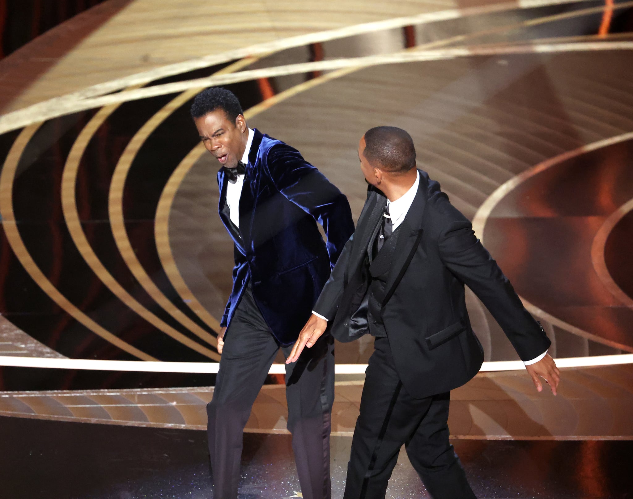 HOLLYWOOD, CA - March 27, 2022.    Will Smith slaps Chris Rock onstage during the show  at the 94th Academy Awards at the Dolby Theatre at Ovation Hollywood on Sunday, March 27, 2022.  (Myung Chun / Los Angeles Times via Getty Images)