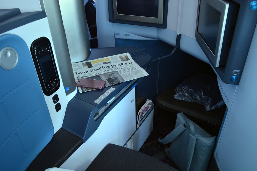 My seat was one in the center of the aisle, so I didn’t have a window view nor the entire nook to myself. However, the seat offers you such privacy that you don’t really ever interact with the person next to you. When you first arrive, the seat has a compartment full of magazines and newspapers, a blanket, and a pillow. The silver compartment opens up to a small space to store glasses or touch up your makeup.