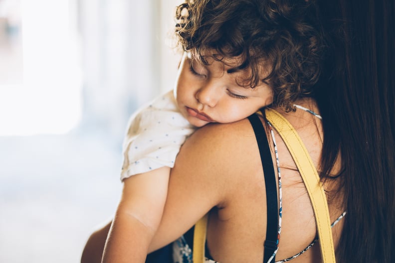 Mother Carrying Her Sleeping little boy on her shoulder