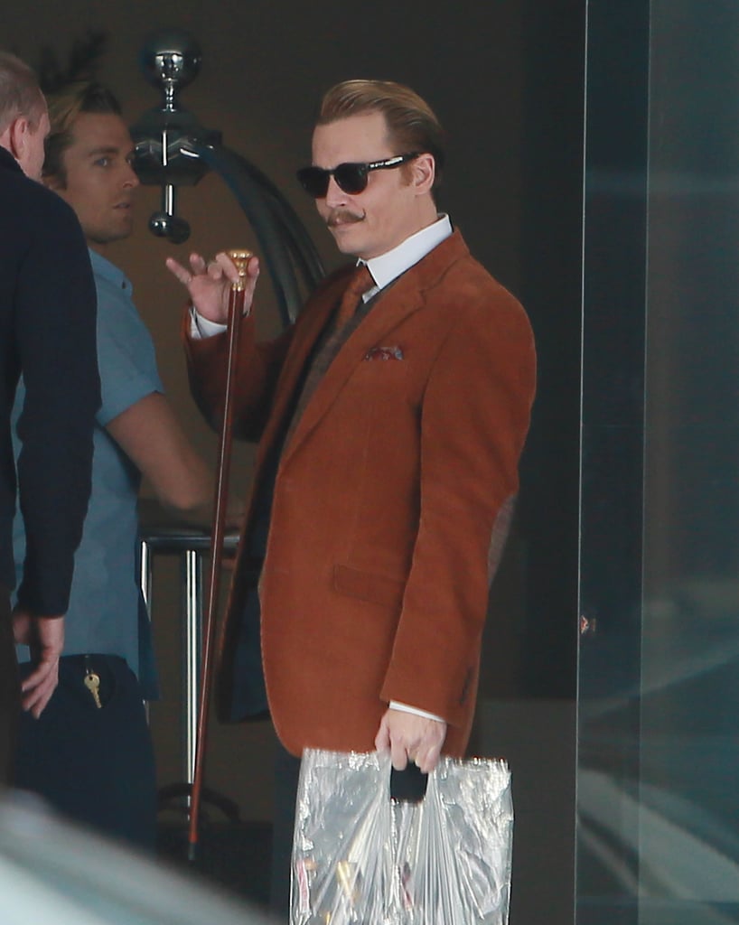 Johnny Depp played the part of a suave art dealer on the set of Mortdecai in LA on Monday.