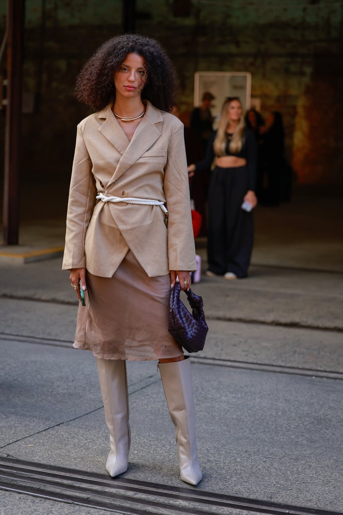 A guest tied a white rope belt around her brown blazer for visual interest and to her top shape.