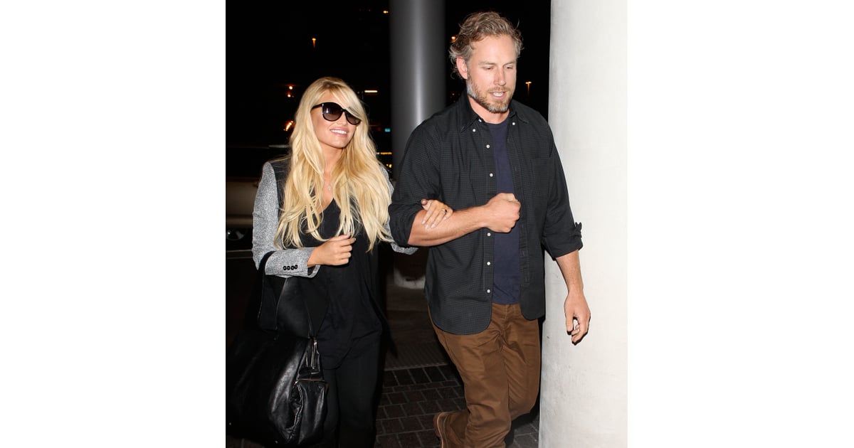 Jessica held on to her man as they made their way through LAX in