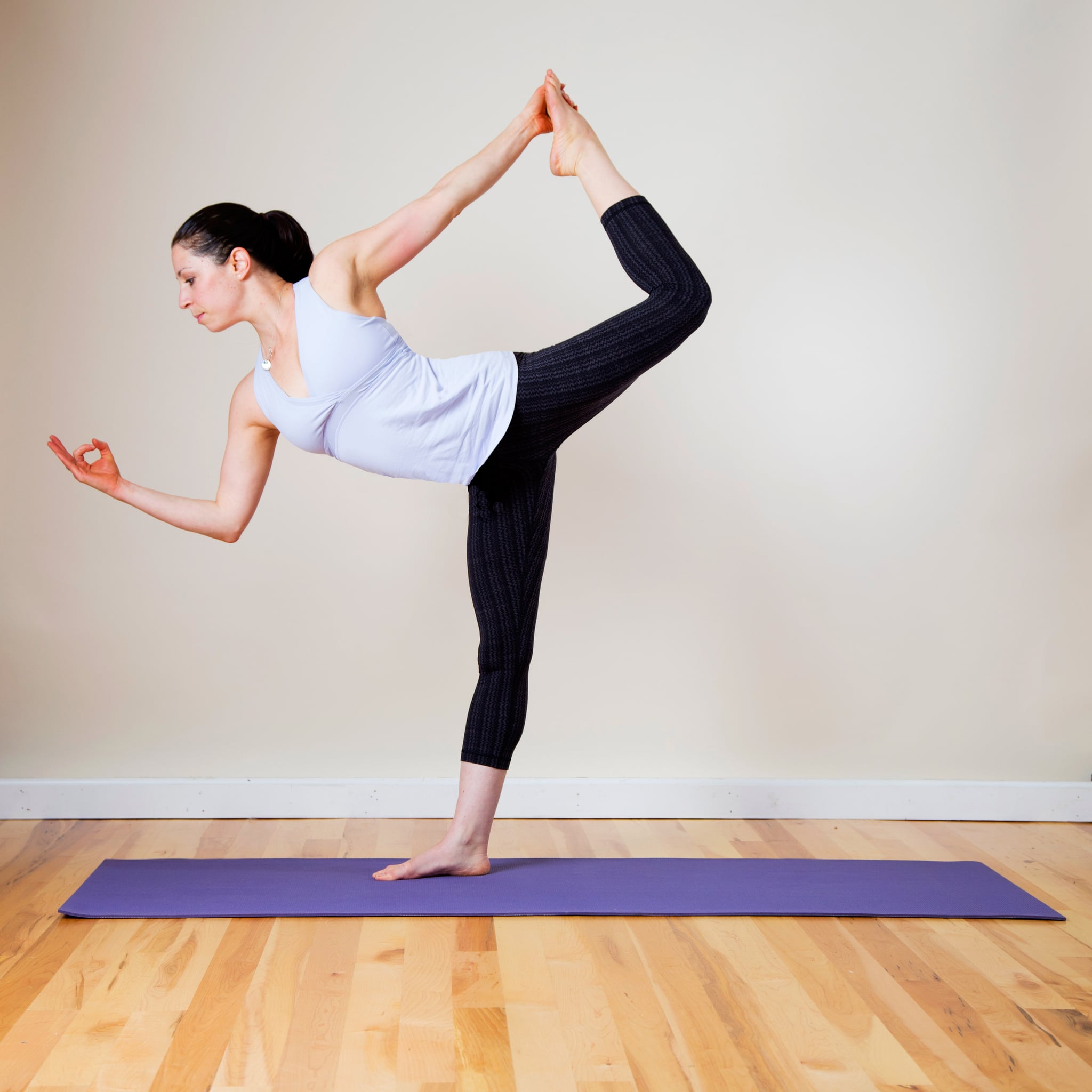 Full length portrait of young woman doing a yoga pose standing with one leg  raised up. Stock Photo | Adobe Stock